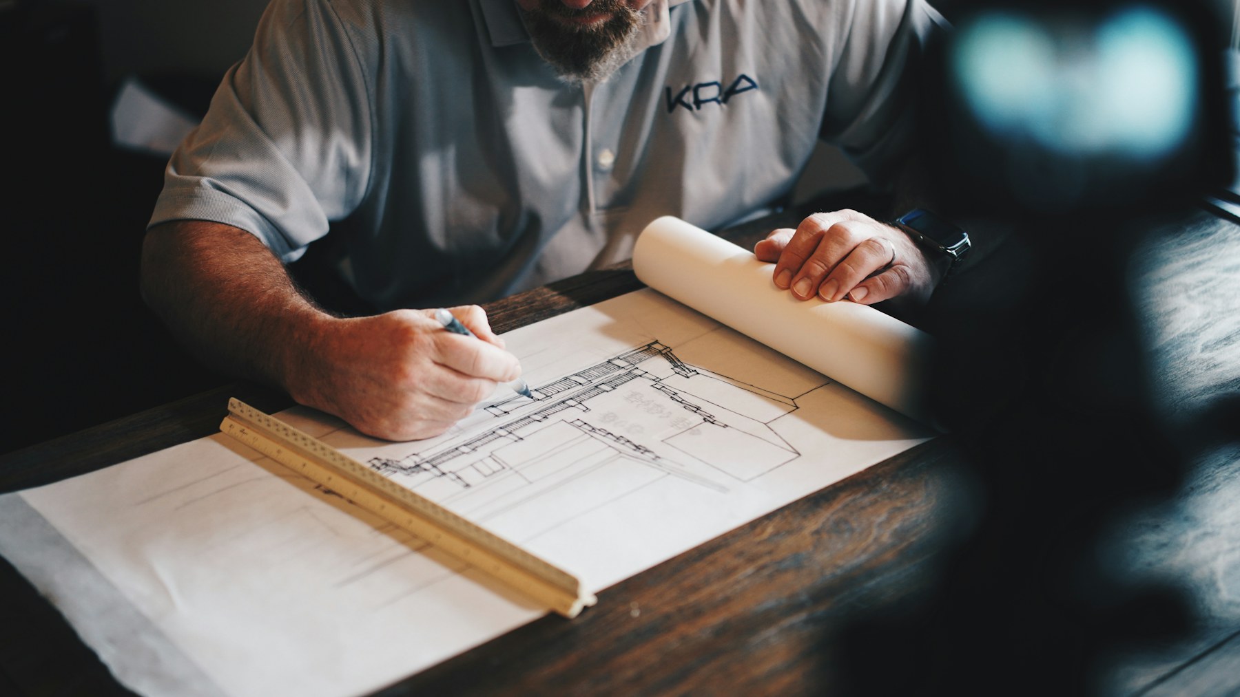 Drafting table with architectural plans in a Kuala Lumpur marketing studio